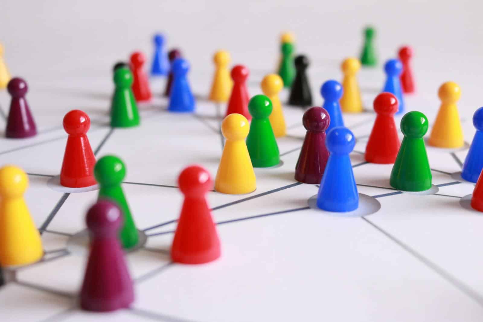 Close Up Photography of Yellow Green Red and Brown Plastic Cones on White Lined Surface